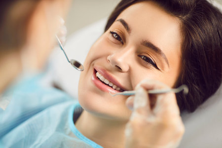 Dental clinic oral health treatment, dentist exam, teeth, gums care for smiling woman healthy at doctor visit, demonstrating whitening teeth procedure result, satisfied with stomatology clinic serviceの写真素材