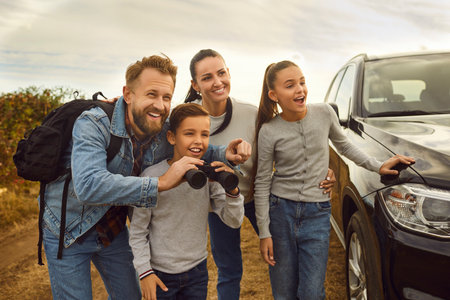 Family travelling by car enjoying recreation camping weekend day outside. Dad with backpack and...