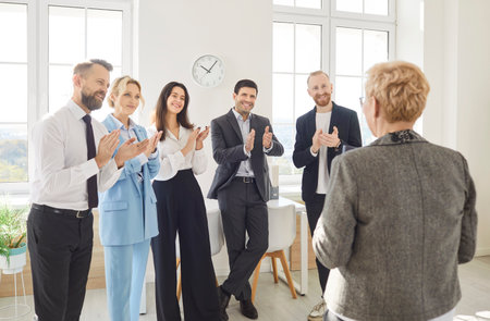 Engaged and diverse business people or colleagues team applauding during a work meeting or presentation in the office. Collaboration, presentation highlights, and discussions among colleagues.の写真素材