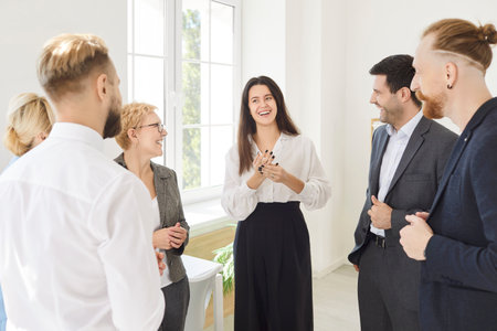 Business people applauding to woman, showing agreement, contract, deal after negotiation, group partners successful strategic discussion, idea, reaching good result, great result representationの写真素材