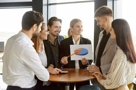 Business people standing at desk on workplace on meeting discussing finance growth. Company employees analyzing data stat and financial report with brainstorming. Teamwork and cooperation concept.の写真素材