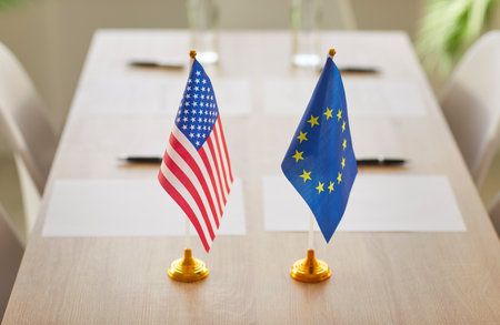 Conference room with USA and European Union flags on table with no people symbolising collaboration and collaboration between countries and governments. Politics and relationships conceptの写真素材