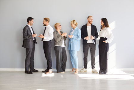 Group of diverse business people communicating and collaborating during a work team meeting in the...