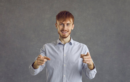 Positive smiling man pointing his index fingers directly at the camera saying I choose you. Smiling...