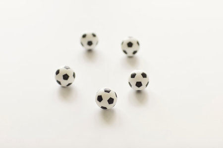 Five small black and white soccer balls arranged in a circle on a clean white background. Ideal for...