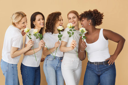 Woman Day celebration concept. Happy multi ethnic women pose with roses in hands, have smiling...