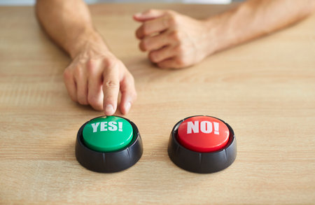 Person hands in moment of decision, finger pressing down on green yes button and contrasting red no,...