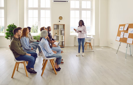 Group of diverse business people on meeting discussing work project sitting in a row in office....
