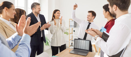 Group of happy young successful business people in formal clothes applauding making a good deal...