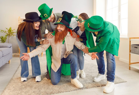 Saint Patrick day fancy dressed people, friend home party, celebration of national Irish culture. Group of people wearing silly green hat, beard, Leprechaun amusing costume happy social entertainmentの写真素材