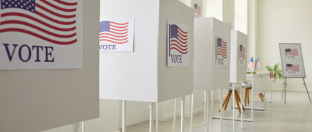 Vote center on Election Day as rows of voting booths adorned with American flags await voters. This...
