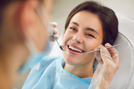 Dentist doctor performing a medical check up on a patient teeth during a visit to hospital. Oral...