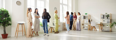 Group of diverse female business people working in office chatting after meeting. Company employees...