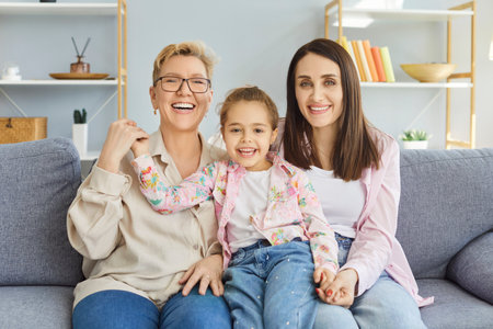 Happy family, child, mother and grandmother friendly portrait at home, sit laughing on comfortable...