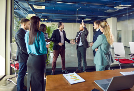 Office boss and active happy male employee good job, excited worker talking hand raising getting...