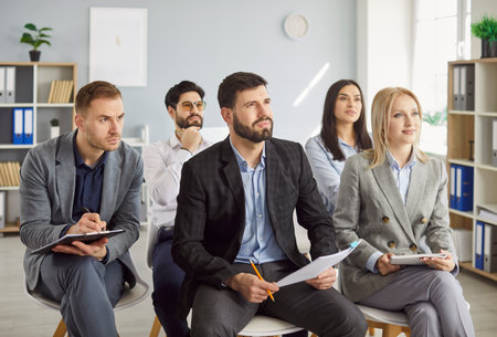 Business team people, diverse businesspeople in office listening explaining strategy at corporate group meeting, staff listen to boss instructing interns at briefing, teaching or developingの写真素材