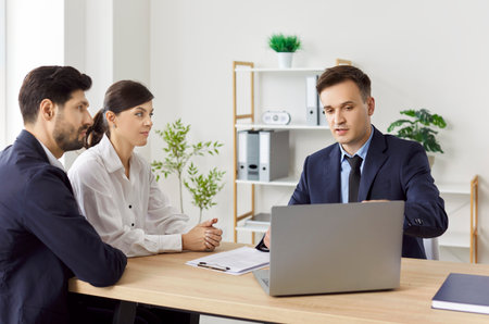 Business people consulting with a lawyer in the office, close-up. A married couple draws up a statement of claim. Concept legal advice for entrepreneurs, corporate law, professional advocacyの写真素材