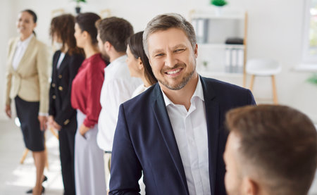 Happy smiling confident man company employee in formal clothes looking cheerful at camera with a...