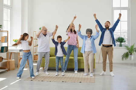 Happy extended multigenerational family all together having fun at home. Funny, overjoyed, excited...
