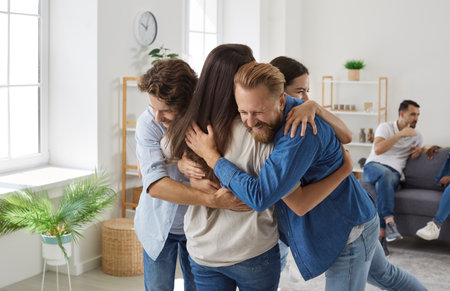 Meeting of best friends. Company of joyful friends who are happy to see each other hug during...