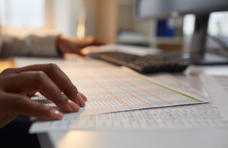 Woman accountant working in the office and doing business paperwork. Close up of the hand of an...