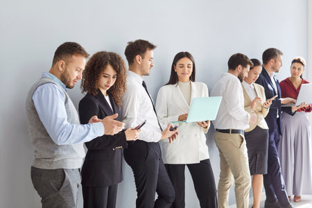Diverse business team applicants waiting standing, businesspeople in row, queue for job interview,...