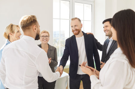 Happy smiling confident business partners shaking hands in office, meeting with project colleagues,...