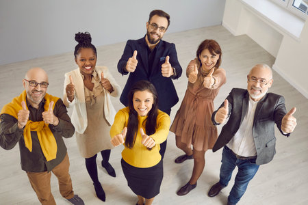 Multiracial team of business people showing thumbs up together. Group of happy multiethnic male and...