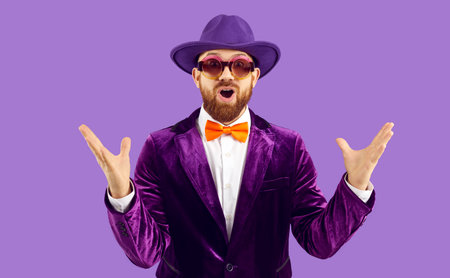 Wow, its unbelievable. Funny man is amazed by something. Happy man with ginger beard, in cool sunglasses, hat, suit and bowtie is looking at camera with expression of genuine surprise on his faceの写真素材