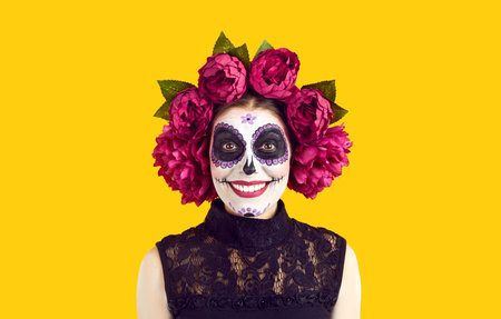 Portrait of a Caucasian young, happy girl with a skeleton makeup on her face and with large flowers...