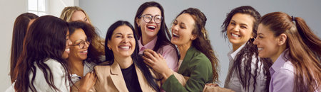 Group of happy cheerful young diverse multiracial women have fun, hug and congratulate their friend and team member on her success and business achievements. Banner background. Recognition conceptの写真素材