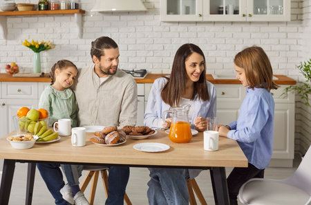 Parents with children enjoy eating meal during family dinner on kitchen at home, sharing leisure and...