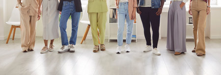 Legs of a group of unrecognizable business people women standing in a row at the office on workplace. Cropped shot of a stylish group of employees or staff in casual clothes. Banner.の写真素材