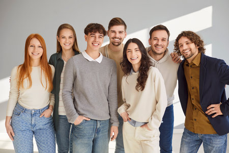 Group portrait of people in team, including students, coworkers, staff, and friends, showcasing crowd and teamwork on gray background in a professional setting with unity and collaboration.の写真素材