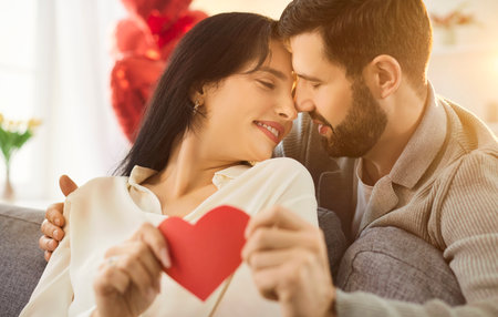 Loving happy Valentine day couple date, affectionate people holding red heart love symbol, close in...