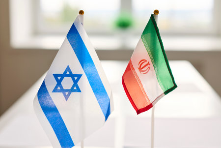 Flags diplomacy meeting on table symbolize negotiations. Miniature Israel and Iran face each other on a conference table, together. Symbolizes diplomatic negotiation and bilateral relations.の写真素材