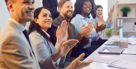 Group of happy business people in an office meeting event, applauding and celebrating success...