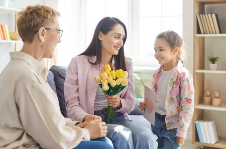 Grandmother and daughter celebrate women day, birthday or mother day with mother by gifting bouquet...