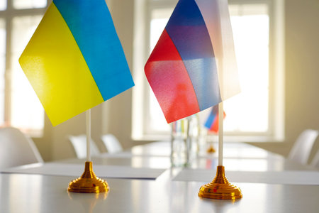 Flags of Ukraine and Russia at negotiations aimed to stop bombing and start troop withdrawal and conflict resolution, end war, restore peace, define future strategy on Crimea issue. Close upの写真素材