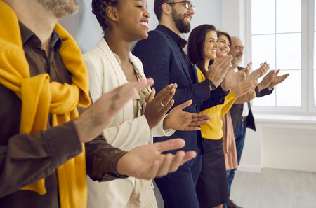 Happy multiracial business people applaud with pleasure after listening to conference or seminar....