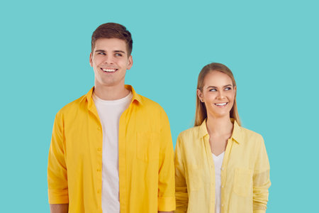 Young attractive Caucasian man and woman dream of happy future together, smiling look up coming up...