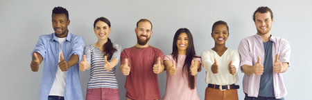 Group portrait of cheerful diverse people giving thumbs up. Team of happy satisfied young men and...