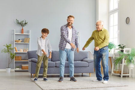 Funny dancing playful family of three generation men, senior grandfather, adult father, small child...