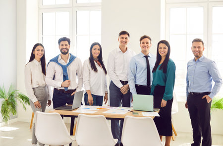 Professional group leader and corporate staff, smiling young people, successful work group at office boardroom, happy diverse business partners looking at camera, career project and human resourceの写真素材