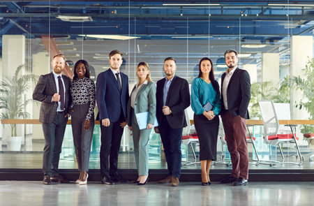 Group of business multiethnic people men and women looking cheerful at camera and smiling indoors....