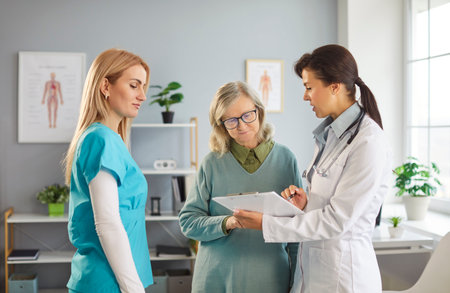 Senior woman assistance with caring female nurse and doctor providing care giving help, supervising, protecting, elder care service, geriatric kind, gentle management for older people, social workの写真素材