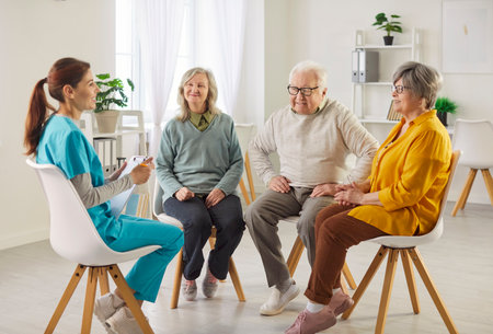 Senior patients attending a medical consultation with a doctor or nurse at a nursing home or hospital. Providing support, help, and healthcare assistance to ensure well-being and comfort.の写真素材