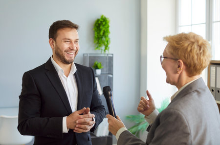 Interview successful business conversation recording, interviewer woman reporter holding microphone...