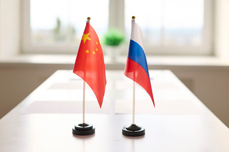 Flags of China and Russia on meeting table. Compact desk flags stand side by side in a conference...