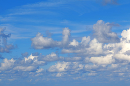 Scattered fluffy clouds in the blue sky
